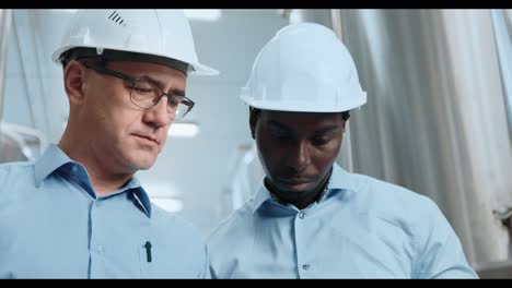 industrial engineers reviewing documents in a facility