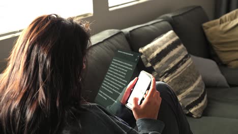 woman on couch looking at smart phone, vfx animation motion graphics overlay of text message