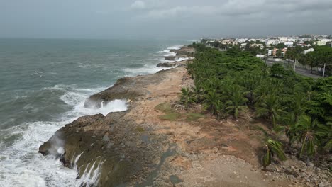 Aerial-footage-of-waves-crashing-against-the-rocky-coastline-after-Hurricane-Beryl