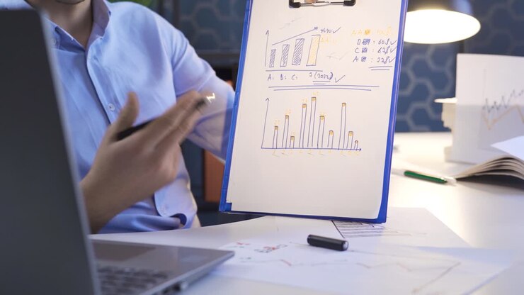 Man interpreting and analyzing financial charts in online meeting.
