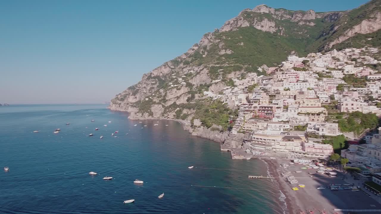 Aerial Drone shot Pan Right looking at Buildings and Beach in Positano, Italy