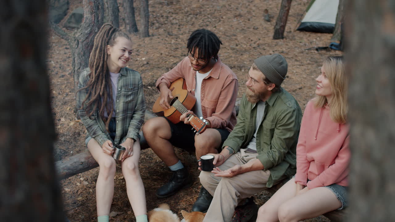 Friends Camping and Playing Guitar