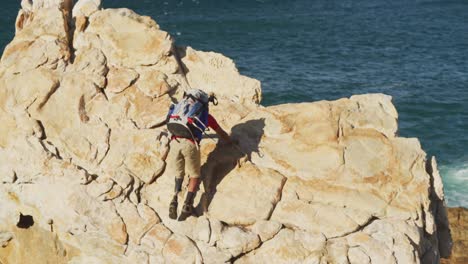 sporty mixed race man with prosthetic leg hiking