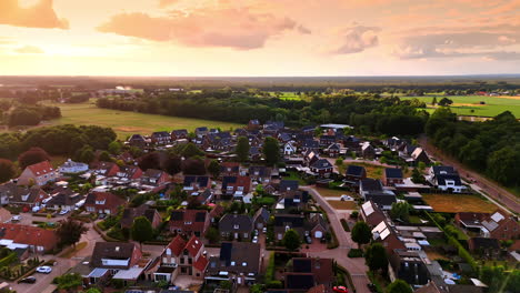 scenic view of a quiet village at sunset. a beautiful sunset illuminates the charming village and its green surroundings, showcasing rows of houses and fields