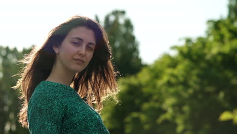 gorgeous italian fashion model posing in her outfit in a park in london at golden hour