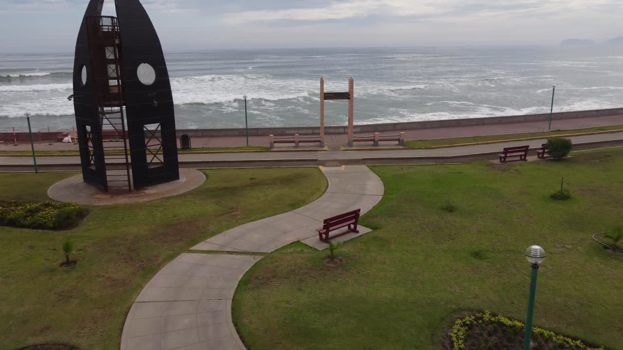 monumento artístico de tablas de surf apuntaladas en círculo en un parque cerca de la playa