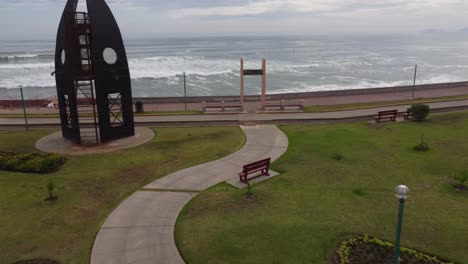 artistic monument of surf boards propped up in a circle in a park near the beach