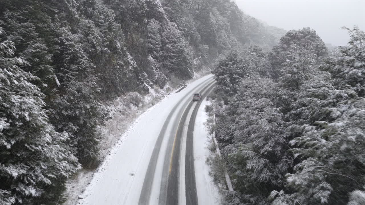 Aerial view of Route 40 covered in snow near Bariloche in Río Negro Patagonia Argentina, winter road trip and adventure travel