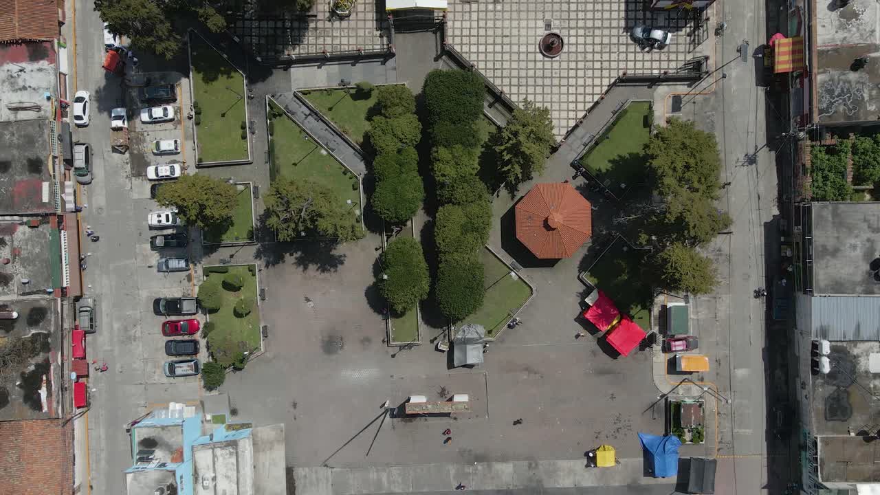 Vista aérea de casas, ruas e igreja no bairro, capturada por drone.