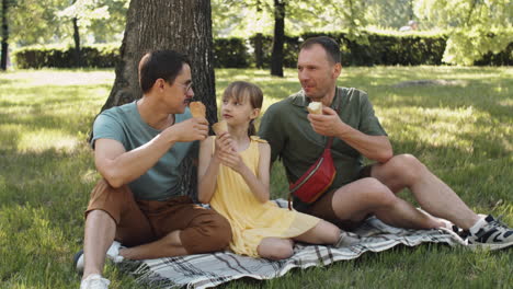 gay couple with kid outdoors