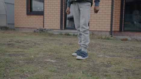 a child playing soccer in the yard