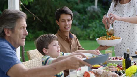 Family-eating-outside-together-in-summer