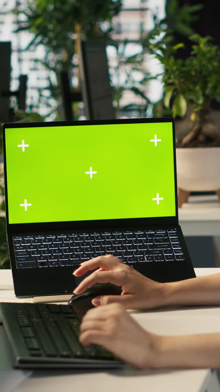 Vertical video Office clerk uses chroma key devices to read data statistics