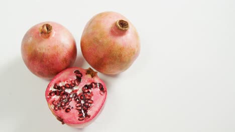 Pomegranate-with-half-piece-on-white-background-4K-4k