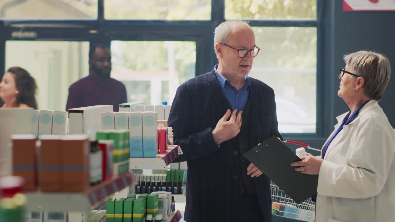 Pharmacist Assisting Senior Man in Pharmacy