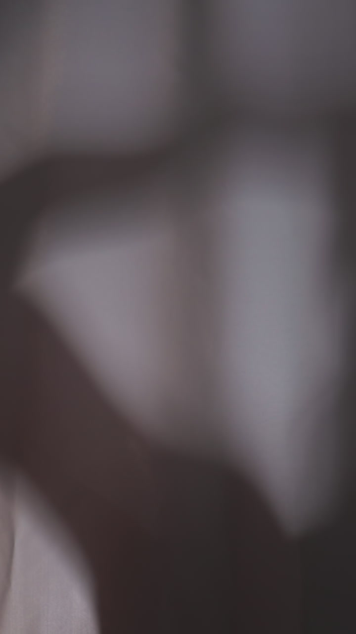 Silhouette of woman taking shower behind curtain. Lady washes hair under water sprays in home bathroom. Woman enjoys routine hygienic procedure