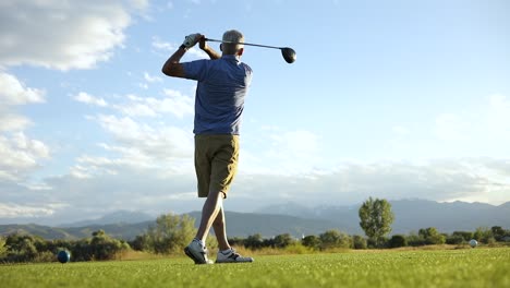 Slow-Motion-shot-of-a-man-driving-a-golf-ball-into-the-fairway