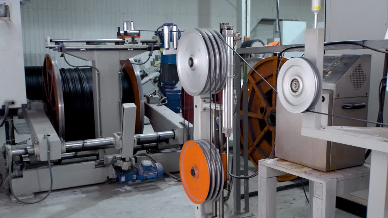 Production of copper wire, bronze cable in reels at factory. Equipment for the production of electric cable