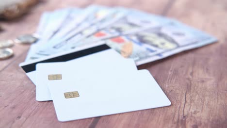 credit cards and money on a wooden table