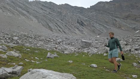 hiker walking carrying rock followed rockies kananaskis alberta canada