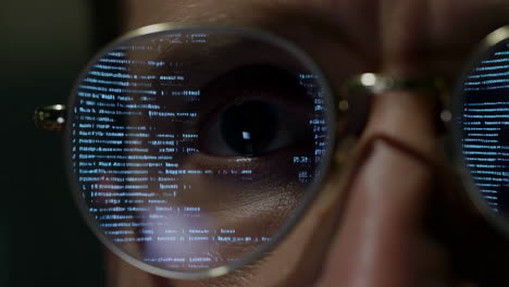 person's eye with digital code reflection in glasses