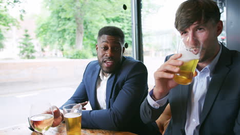 point of view shot of businessmen meeting and talking in bar together