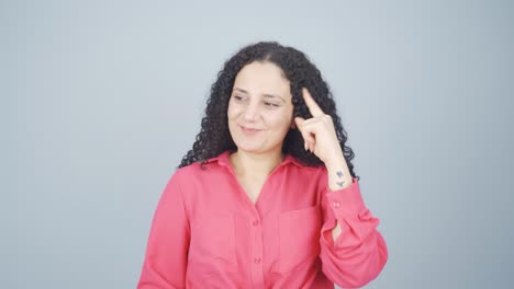 Thoughtful-young-woman-towards-camera-comes-up-with-an-idea.