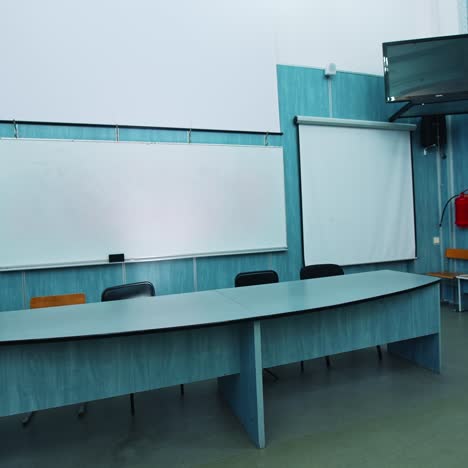 modern interior of lecture hall. white board and presidium table in the university classroom. empty auditorium with new equipment