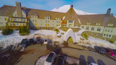 a majestic rising aerial shot above a massive hotel or ski lodge to reveal mt hood oregon