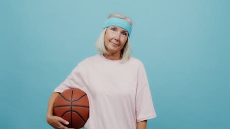 senior woman holding a basketball