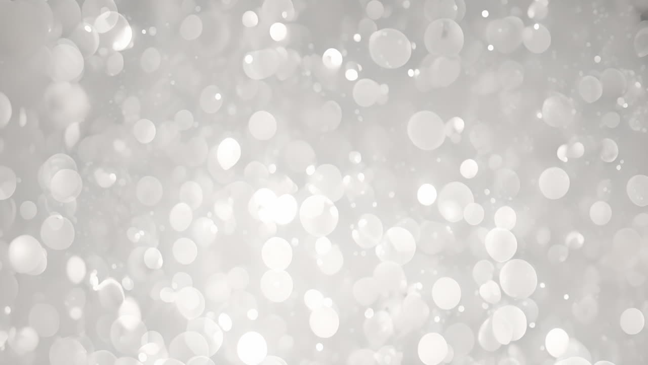 Bokeh light circles animating over soft gray background