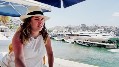 athens coastal cafe: young woman in summer attire