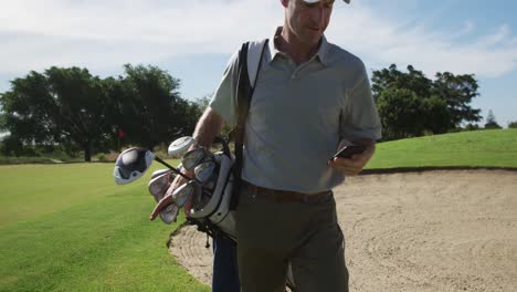 Golfista-Caucásico-Usando-Su-Teléfono-Inteligente-En-Un-Campo-De-Golf