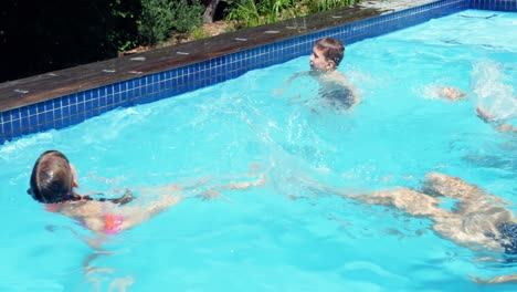 happy family having fun in swimming pool