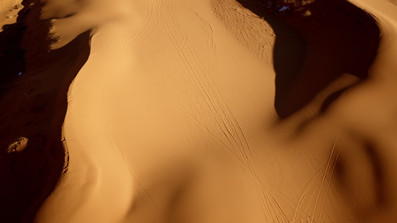 Overhead drone footage reveals pink-hued dunes with mesmerizing shapes and shades in southern Utah.