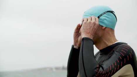 sportsman in wetsuit wearing goggles