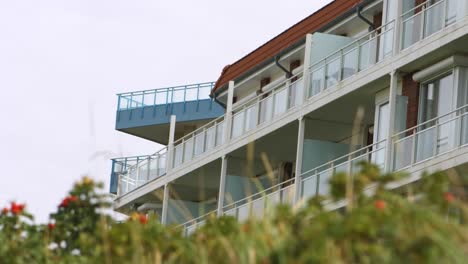 slow camera tilt and focus shift showing some balconies of an apartment building