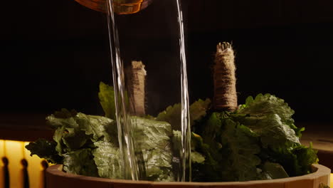 pouring water on oak sauna broom