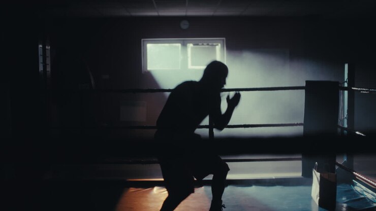 Silhouette of Boxer Training in a Ring