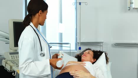 doctor doing ultrasound scan on pregnant woman