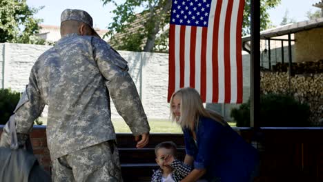 excited family meeting serviceman at home