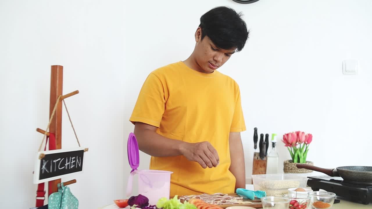 Young Man Preparing Food in a Kitchen