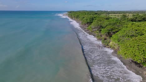 aerial flight along scenic coastline of rocky palenque beach and blue sea of dominican republic