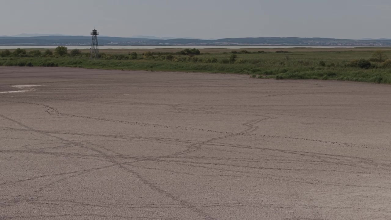 A close-up view of completely dry, cracked earth creates a detailed natural pattern across the entire frame.