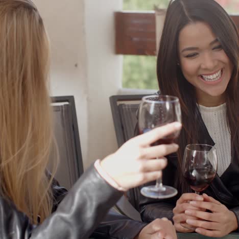 woman laughing with friend over wine