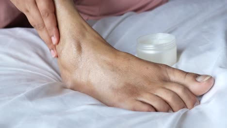 applying cream to foot and ankle