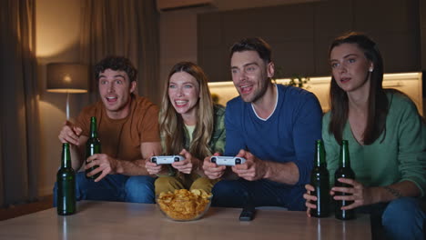 competitive gamers rejoicing video game win at apartment couch. friends playing