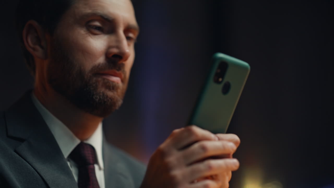 Night boss hands messaging smartphone in dark cabinet closeup. Happy businessman