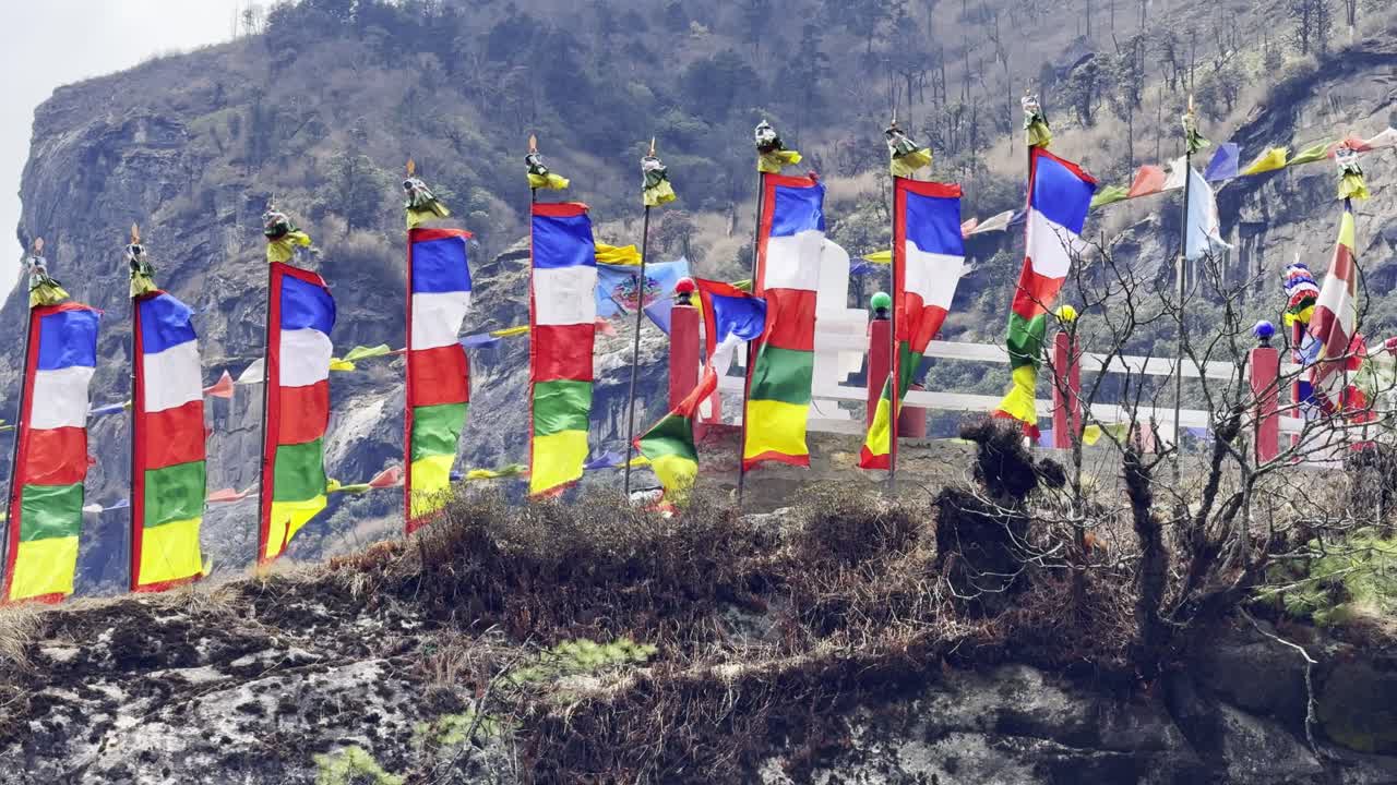 Vibrant Buddhist prayer flags flutter in the mountain wind along the trail to Everest Base Camp—symbols of peace, culture, and Himalayan spirit.