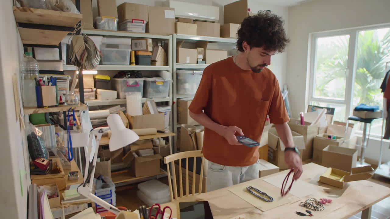 Man Taking Photos of Jewelry with Phone for Selling Online